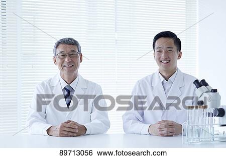 Stock Photograph - Japanese researchers in the lab. Fotosearch
