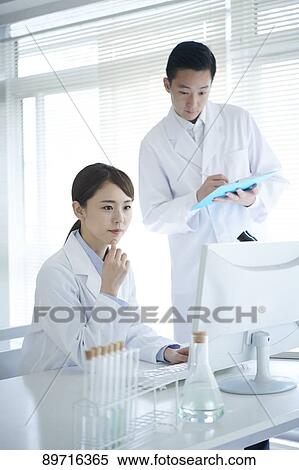 Stock Photography - Japanese researchers in the lab. Fotosearch
