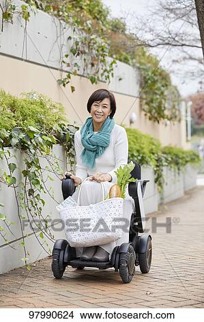 Japanese senior woman on electric wheelchair View Large Photo Image Picture - Japanese senior woman on electric wheelchair. Fotosearch