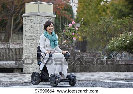 Japanese senior woman on electric wheelchair View Large Photo Image Picture - Japanese senior woman on electric wheelchair. Fotosearch