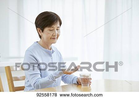 Japanese senior woman taking pills View Large Photo Image Stock Photo - Japanese senior woman taking pills. Fotosearch