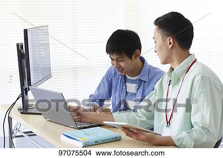 Japanese teenager studying programming View Large Photo Image Picture - Japanese teenager studying programming. Fotosearch