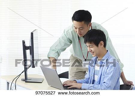 Stock Photo - Japanese teenager studying programming. Fotosearch