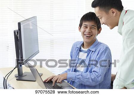 Stock Photo - Japanese teenager studying programming. Fotosearch