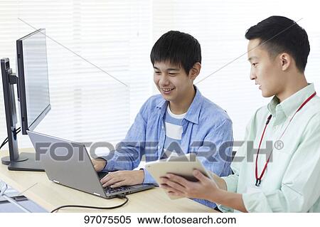 Stock Photography - Japanese teenager studying programming. Fotosearch