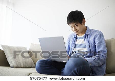 Stock Photo - Japanese teenager with laptop. Fotosearch