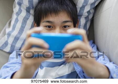 Stock Photo - Japanese teenager with smartphone. Fotosearch