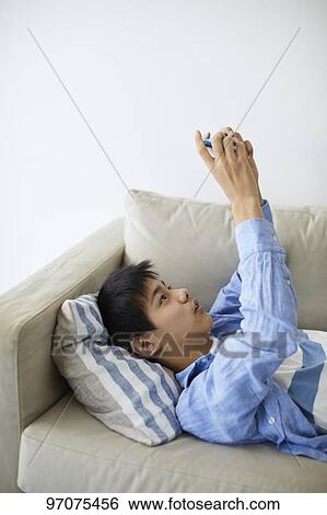 Stock Photograph - Japanese teenager with smartphone. Fotosearch