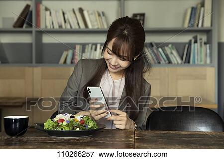Japanese woman at a cafe View Large Photo Image Stock Photo - Japanese woman at a cafe. Fotosearch
