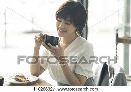 Japanese woman at a cafe View Large Photo Image Stock Photo - Japanese woman at a cafe. Fotosearch