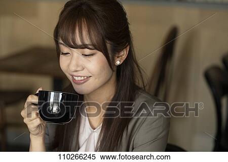 Japanese woman at a cafe View Large Photo Image Stock Photography - Japanese woman at a cafe. Fotosearch