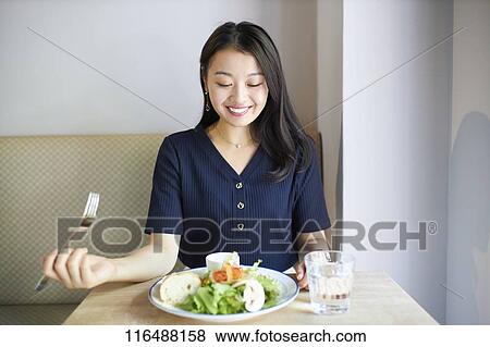 Japanese woman at a restaurant View Large Photo Image Stock Photo - Japanese woman at a restaurant. Fotosearch