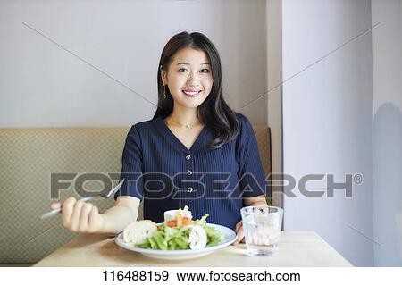 Japanese woman at a restaurant View Large Photo Image Stock Photo - Japanese woman at a restaurant. Fotosearch