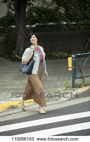 Stock Image - Japanese woman downtown. Fotosearch