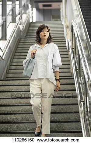 Stock Image - Japanese woman downtown. Fotosearch