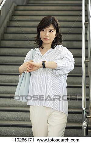 Stock Image - Japanese woman downtown. Fotosearch