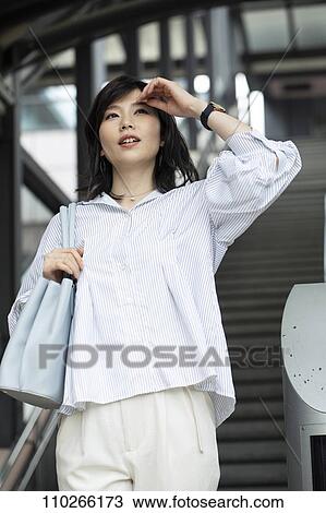 Stock Image - Japanese woman downtown. Fotosearch