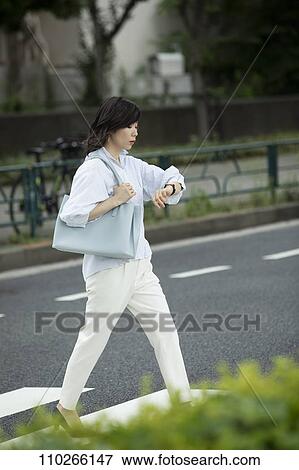 Stock Photo - Japanese woman downtown. Fotosearch