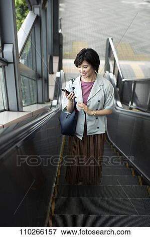 Stock Photo - Japanese woman downtown. Fotosearch