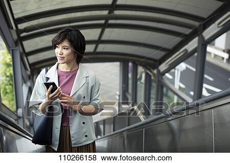 Stock Photo - Japanese woman downtown. Fotosearch