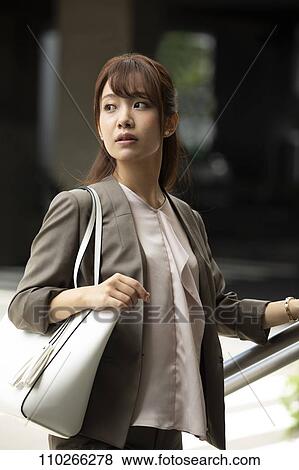 Stock Photo - Japanese woman downtown. Fotosearch