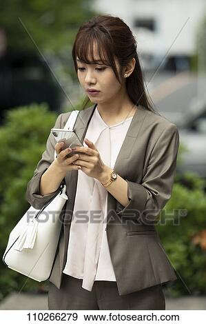 Stock Photo - Japanese woman downtown. Fotosearch