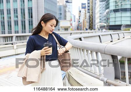 Picture - Japanese woman downtown Tokyo. Fotosearch