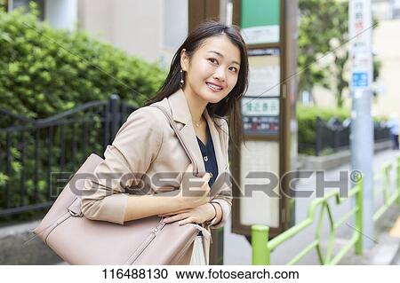 Stock Image - Japanese woman downtown Tokyo. Fotosearch