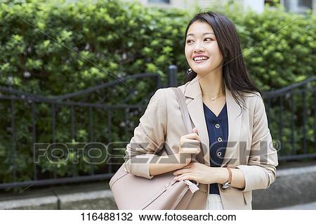 Stock Image - Japanese woman downtown Tokyo. Fotosearch