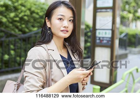 Japanese woman downtown Tokyo View Large Photo Image Stock Photo - Japanese woman downtown Tokyo. Fotosearch