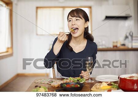 Stock Photo - Japanese woman having home party. Fotosearch