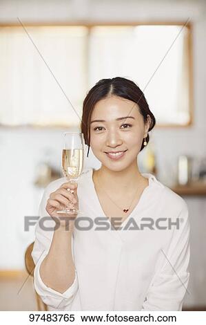 Stock Photography - Japanese woman having home party. Fotosearch