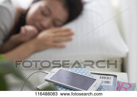 Stock Image - Japanese woman in bed. Fotosearch