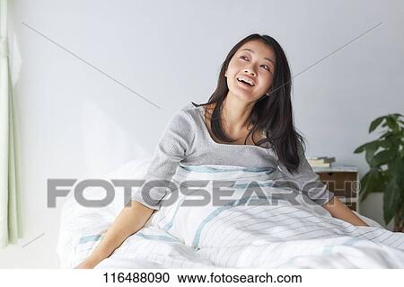 Stock Image - Japanese woman in bed. Fotosearch
