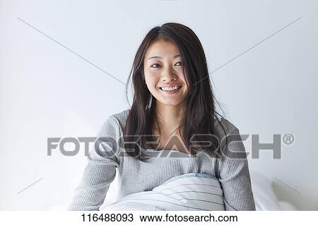 Stock Image - Japanese woman in bed. Fotosearch