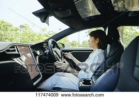 Japanese woman in self driving car View Large Photo Image Stock Photo - Japanese woman in self driving car. Fotosearch