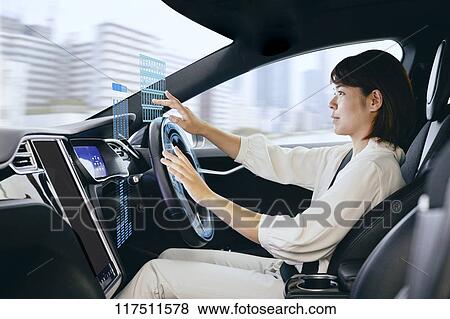 Stock Photo - Japanese woman in self driving car. Fotosearch