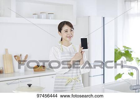 Japanese woman in the kitchen View Large Photo Image Picture - Japanese woman in the kitchen. Fotosearch