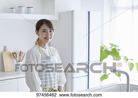 Japanese woman in the kitchen View Large Photo Image Stock Image - Japanese woman in the kitchen. Fotosearch