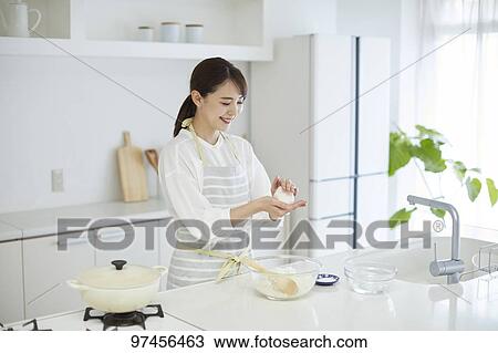Japanese woman in the kitchen View Large Photo Image Stock Image - Japanese woman in the kitchen. Fotosearch