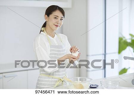 Japanese woman in the kitchen View Large Photo Image Stock Image - Japanese woman in the kitchen. Fotosearch