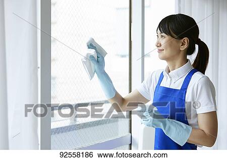 Stock Photograph - Japanese woman wearing apron at home. Fotosearch