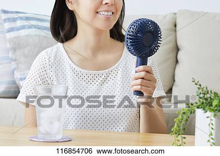 Stock Photograph - Japanese woman with portable fan. Fotosearch