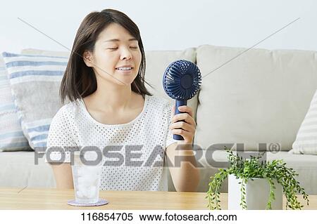 Stock Photography - Japanese woman with portable fan. Fotosearch