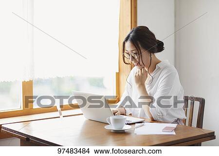 Picture - Japanese woman working at a cafe. Fotosearch