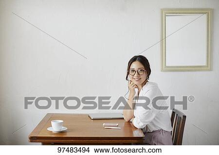 Japanese woman working at a cafe View Large Photo Image Picture - Japanese woman working at a cafe. Fotosearch