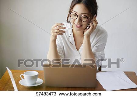 Japanese woman working at a cafe View Large Photo Image Stock Image - Japanese woman working at a cafe. Fotosearch