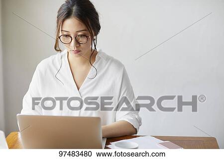 Japanese woman working at a cafe View Large Photo Image Stock Image - Japanese woman working at a cafe. Fotosearch