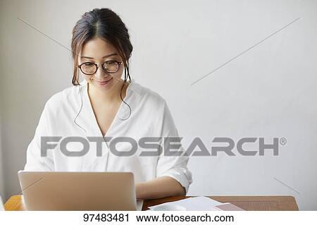 Japanese woman working at a cafe View Large Photo Image Stock Image - Japanese woman working at a cafe. Fotosearch