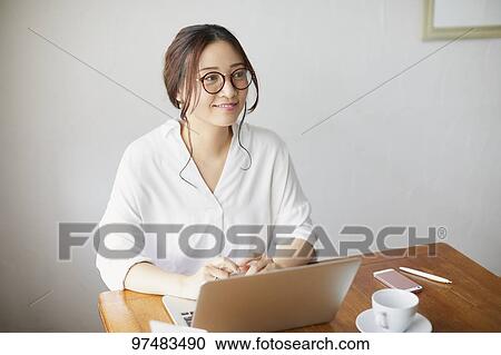 Japanese woman working at a cafe View Large Photo Image Stock Image - Japanese woman working at a cafe. Fotosearch